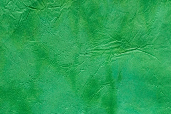 Green watercolor painted background texture on creased paper — Stock Photo, Image