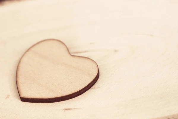 Wooden heart on wooden background texture macro — Stock Photo, Image