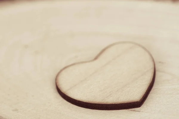 Wooden heart on wooden background texture macro — Stock Photo, Image