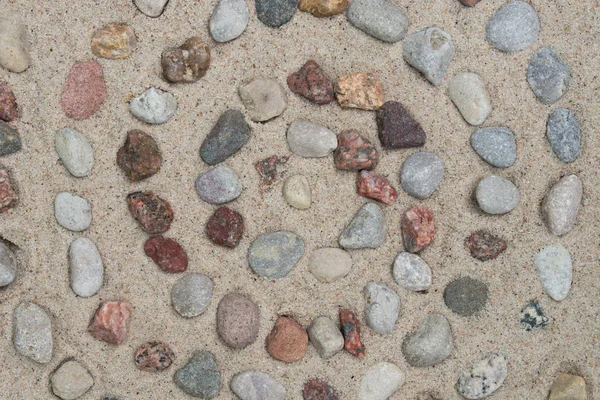 Spiral pattern made of pebbes on sand — Stock Photo, Image