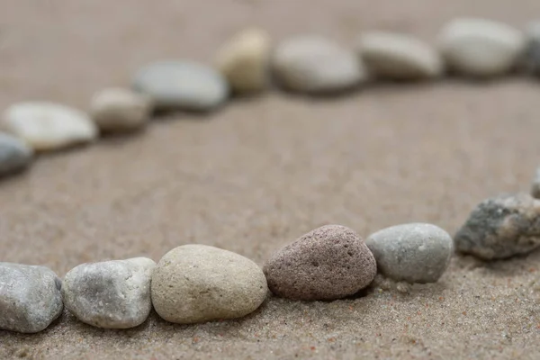 Lines of pebbles on sand macro — Stock Photo, Image