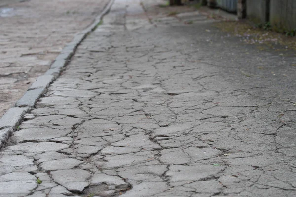 old cracked concrete sidewalk