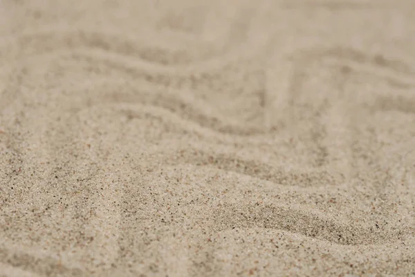 Wellenmuster auf Sand Hintergrund selektiver Fokus — Stockfoto