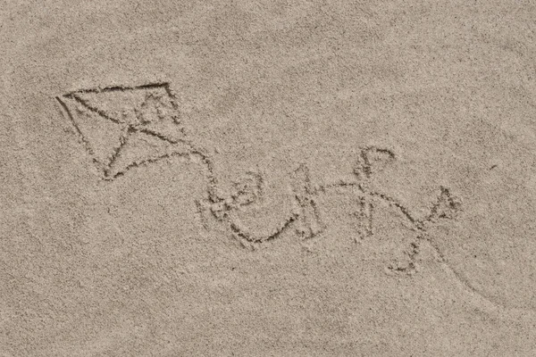 Kite - drawing on sand — Stock Photo, Image