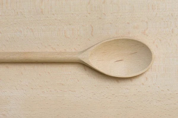 Cucchiaio di legno sul tagliere di legno — Foto Stock