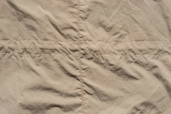 Increspato tessuto beige sfondo texture — Foto Stock