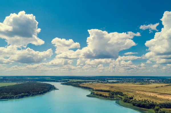 Aerial view of countryside and river. Blue sky with beautiful clouds