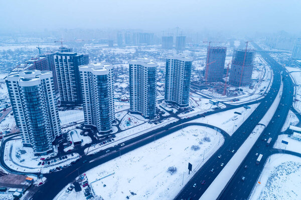 Skyline, commuter town, Kiev city in blizzard. Aerial view of Left bank of the Dnieper River