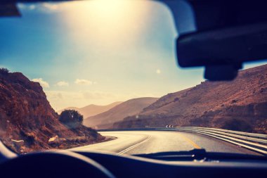 Güneşli bir günde bir rüzgarlı dağ yolda arabayı. Arad Masada en yolu. Ön cam dan güzel dağ manzaraya görüntüleyin. İsrail