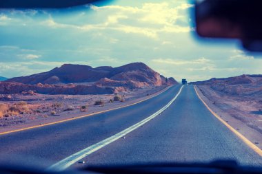 Güneşli bir günde bir rüzgarlı dağ yolda arabayı. Arad Masada en yolu. Ön cam dan güzel dağ manzaraya görüntüleyin. İsrail