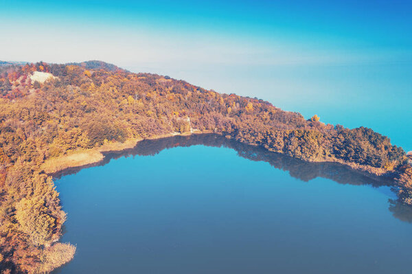 Picturesque mountain lake in autumn. Lake near the sea. Beautiful wild nature. Aerial view