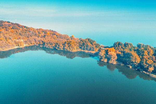 Picturesque mountain lake in autumn. Lake near the sea. Beautiful wild nature. Aerial view