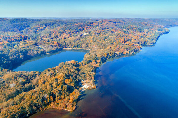 Picturesque mountain forest lake in autumn at sunrise. Lake near the sea. Beautiful wild nature. Aerial view