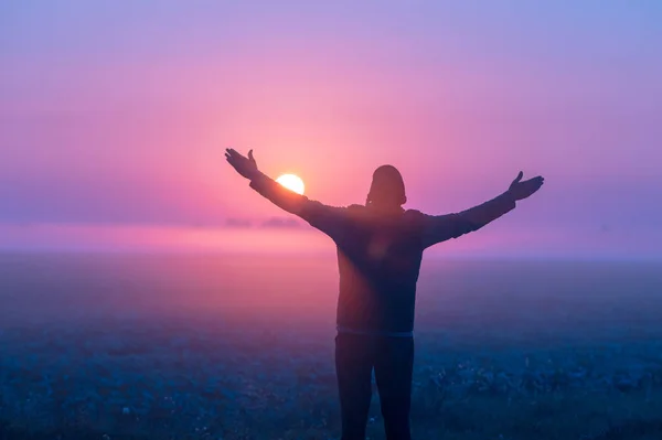 Man His Hands Air Stands Field Early Morning Looks Sunrise — Stock Photo, Image