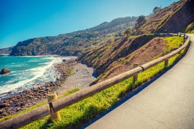 Güneşli bir günde deniz boyunca dağ yolu