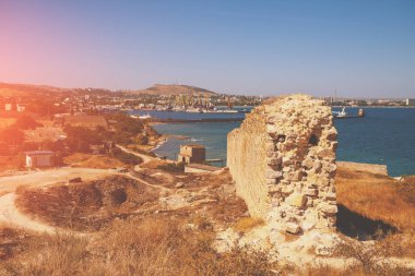 Ruins of the Genoese fortress of Caffa (Feodosia) Crimea. Rocky seashore. Sea nature landscape. View of the sea and Feodosia city from the mount. Port, harbor. clipart
