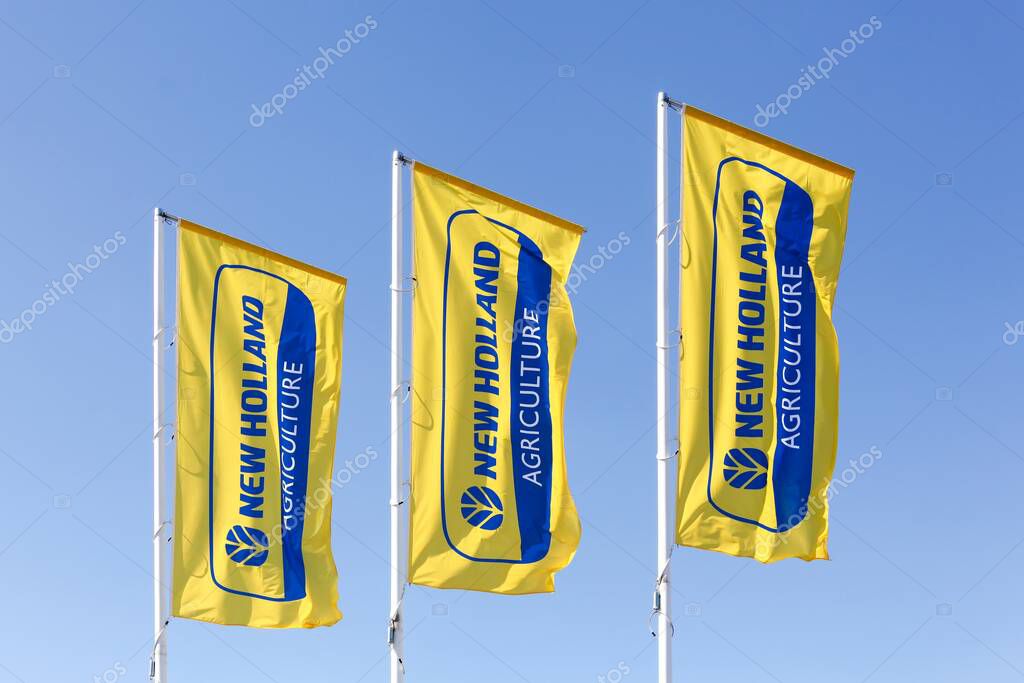 Autun, France - July 5, 2020: New Holland Agriculture flags. New Holland is a brand agricultural equipment manufactured by CNH Industrial