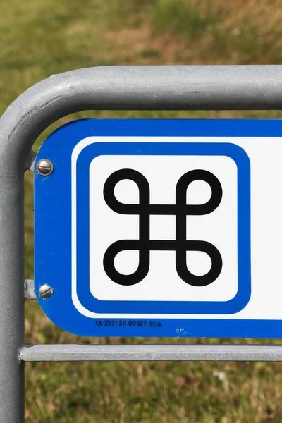 Looped square symbol on a road sign in Denmark