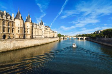 The historic River Seine in Paris, France with a boat cruising by. clipart