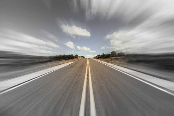 Long desert highway in New Mexico with motion blur.