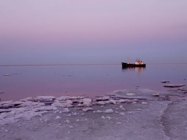 fishing boat on a mirror pink lake