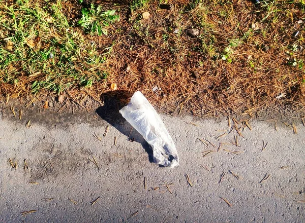 cellophane bag littered with garbage on the road