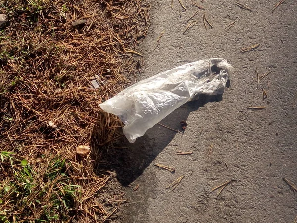 cellophane bag littered with garbage on the road