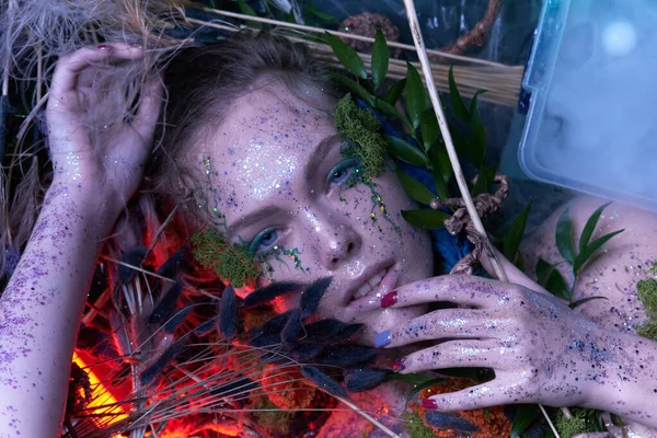 Field mermaid lies on herbs and flowers. nymph looks on camera, — Stock Photo, Image