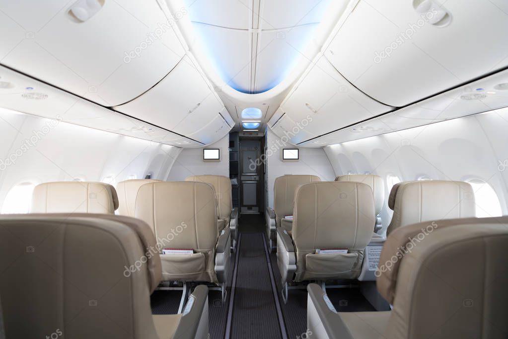Empty passenger airplane seats in cabin. Interior in modern airplane