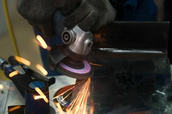 Worker using machine for coating and overlay steel for maintenance and repair in factory.