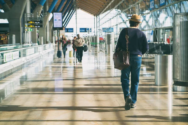 流行に敏感な男性旅客ターミナルの出発空港で歩きながらバックパックを運ぶします 流行に敏感な Mantraveler 旅行記 — ストック写真