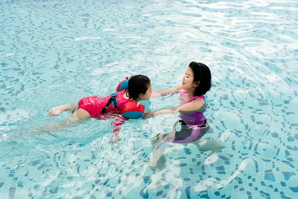 Top view of Asian Mother and child swimming in the pool. Happy m — Stock Photo, Image