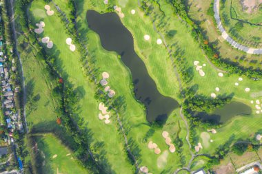 Şehirde Golf Sahası ve evlerin havadan panoramik görünümü.