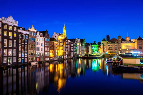 Canals and tradition house in Amsterdam at night. Amsterdam is t