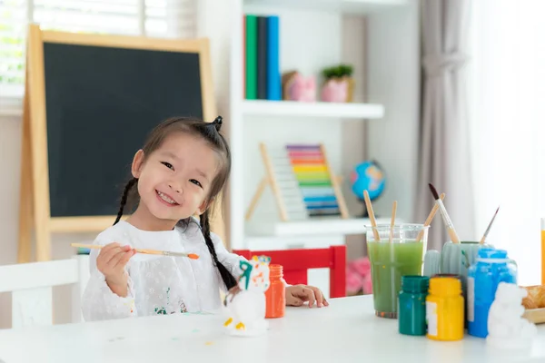 Asian Kindergarten School Girl Painting Plaster Doll Acrylic Water Color Royalty Free Stock Photos