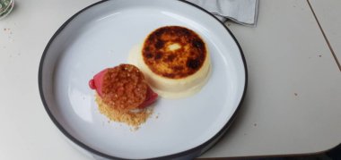 a top view of a bowl of cake on a white table