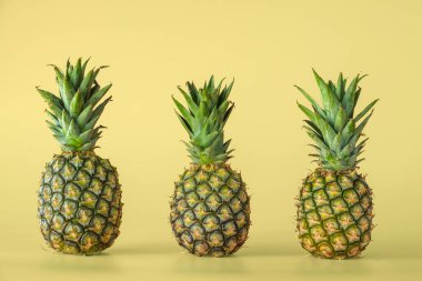 Sarı arka planda izole edilmiş ananas meyvesi. Sağlıklı yaşam tarzı kavramı.