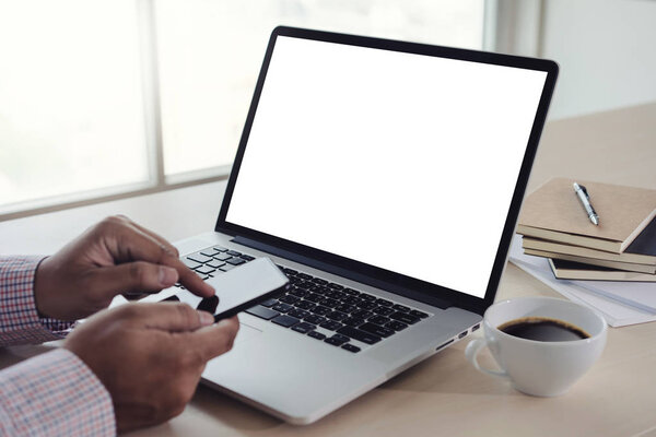 man of business man hand working on laptop computer blank white screen laptop  on vintage wooden