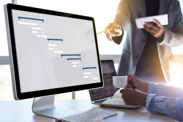 Business People Analyzing Project Management Updated Gantt Chart — стокове фото