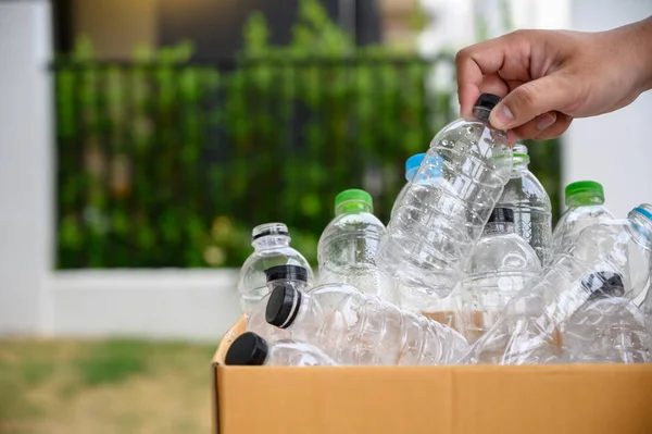 man hand putting plastic reuse for recycling concept environment