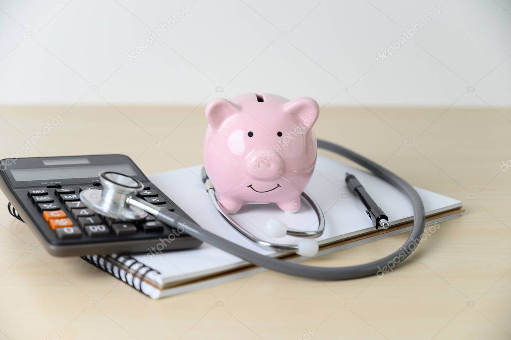 Piggy bank with stethoscope  financial checkup or saving for med