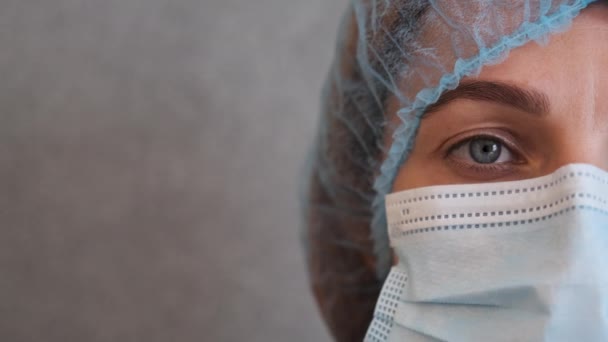 Медсестра в защитной медицинской фуражке и хирургической маске для лица во время коронавируса — стоковое видео