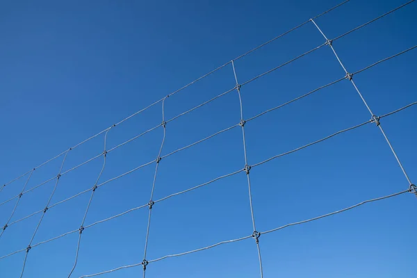 Wire fences with blue sky background copy space.