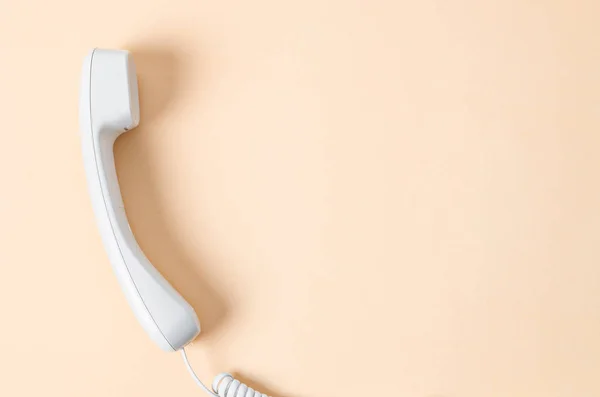 White office desk phone on yellow background. — Stock Photo, Image