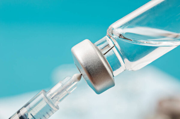 Vaccine vial dose with needle syringe.