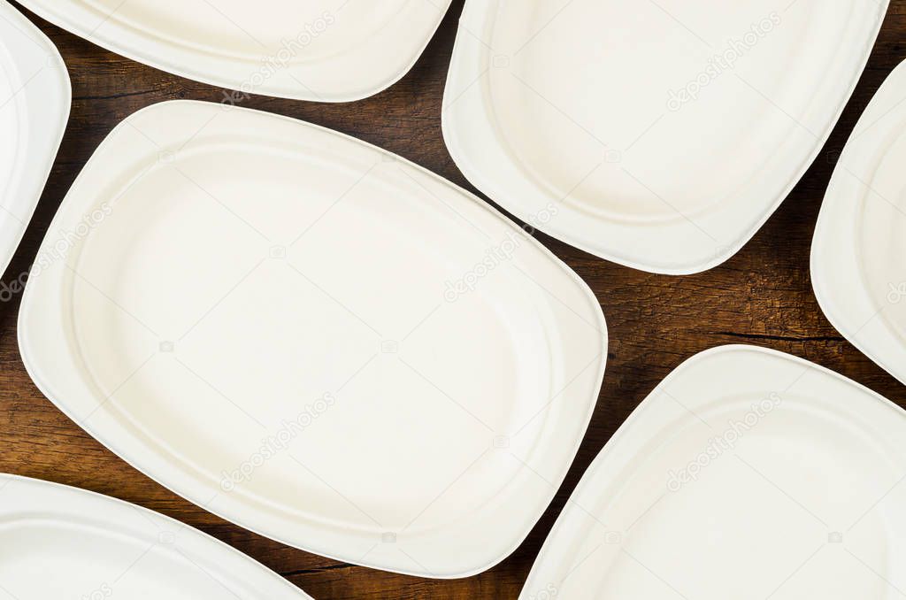 Biodegradable dish on wooden background.
