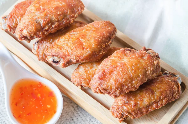 Fried chicken wing with chilli sauce.