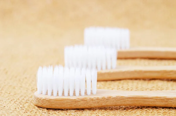 Bamboo toothbrushes on sack. — Stock Photo, Image