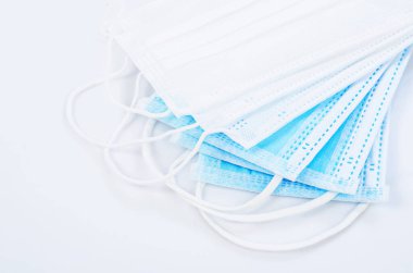 Tıbbi maske ya da plastik kulaklıklı cerrahi maske. Ağız ve burnu örtmek için tipik 3 katlı cerrahi maske. Bakterilerin prosedür maskesi. Koruma kavramı.