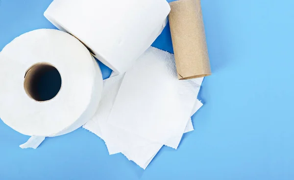 Tissue paper rolls on blue background.